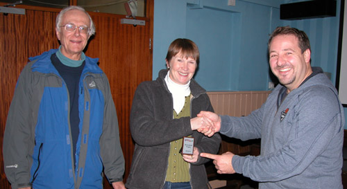 Anne and Tony receive the mini shield from Franc